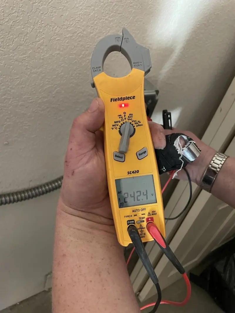 Voltage testing with clamp meter during Ceiling Fan Installation in Bolton